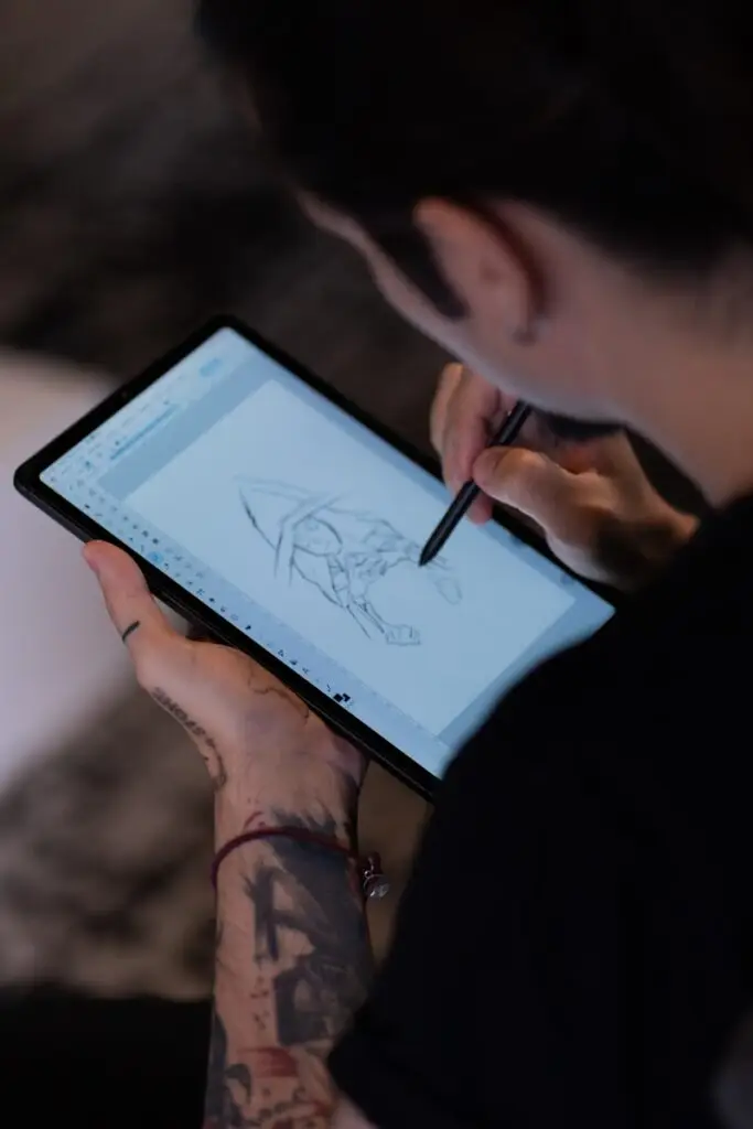 A person with a pen and a tablet